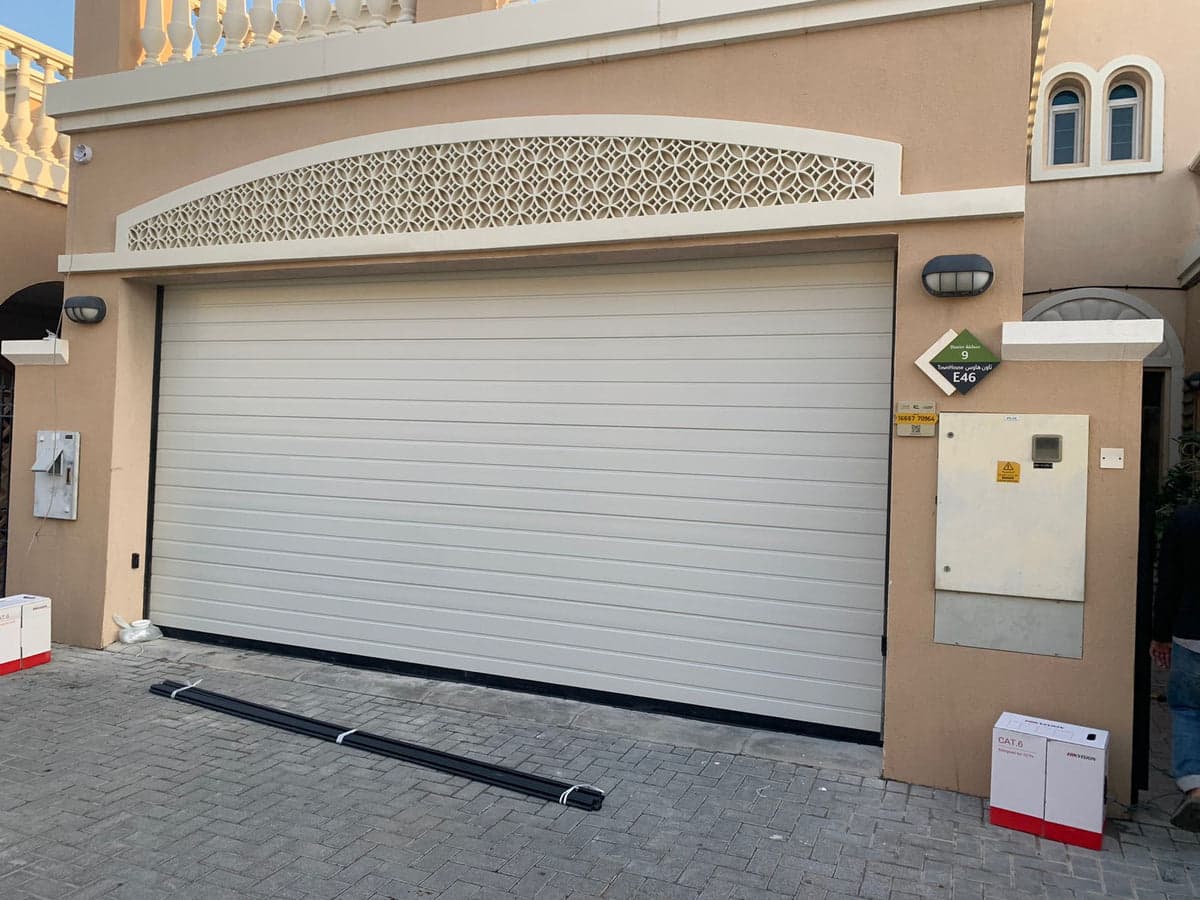 Off-white overhead garage door installed by BAB ALSARAY