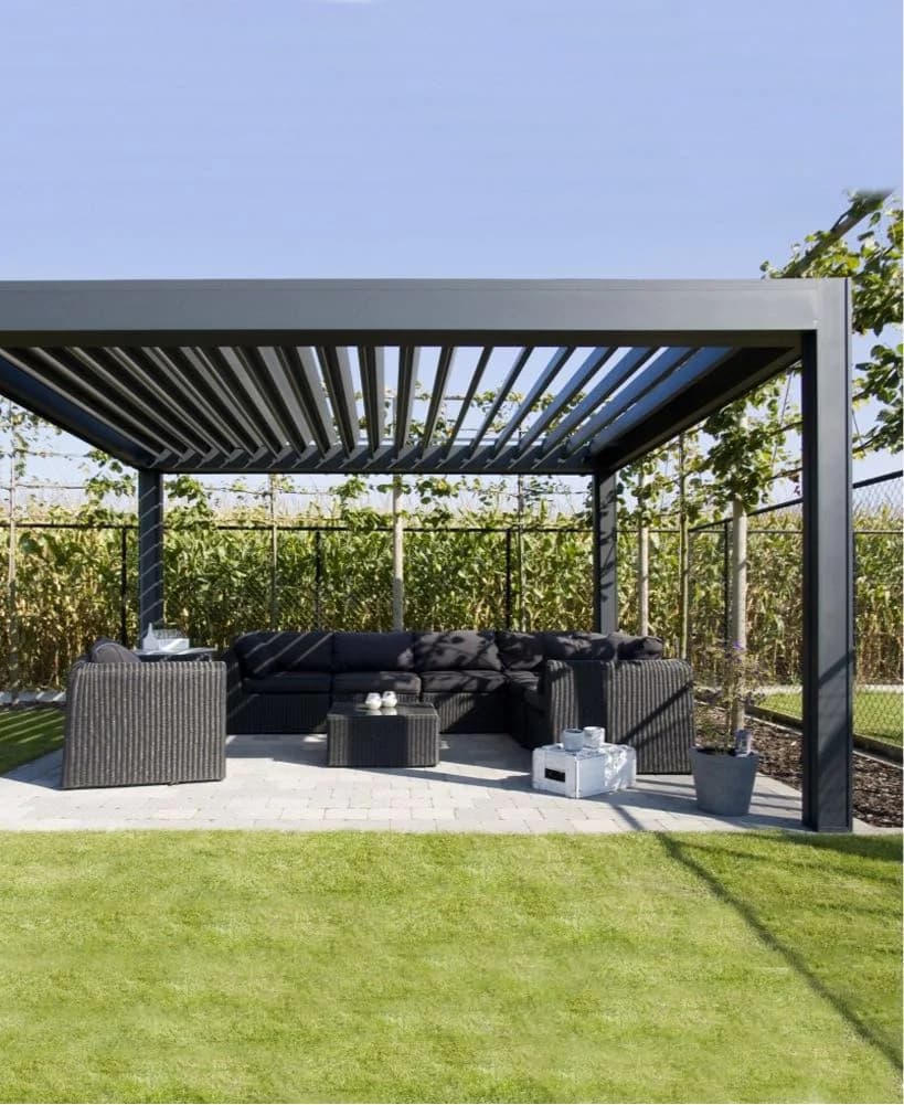 Design reference showing a dark fixed-slat pergola above garden seating